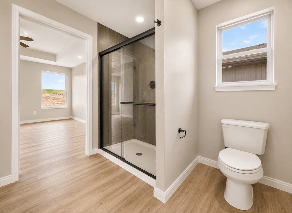 Clear Creek Properties — bathroom with walk-in shower and LVP flooring