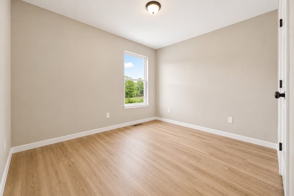 Clear Creek Properties — bedroom with LVP flooring and white trim