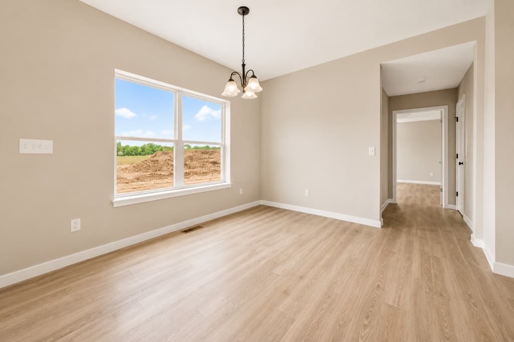 Clear Creek Properties — dining area with LVP flooring and chandelier
