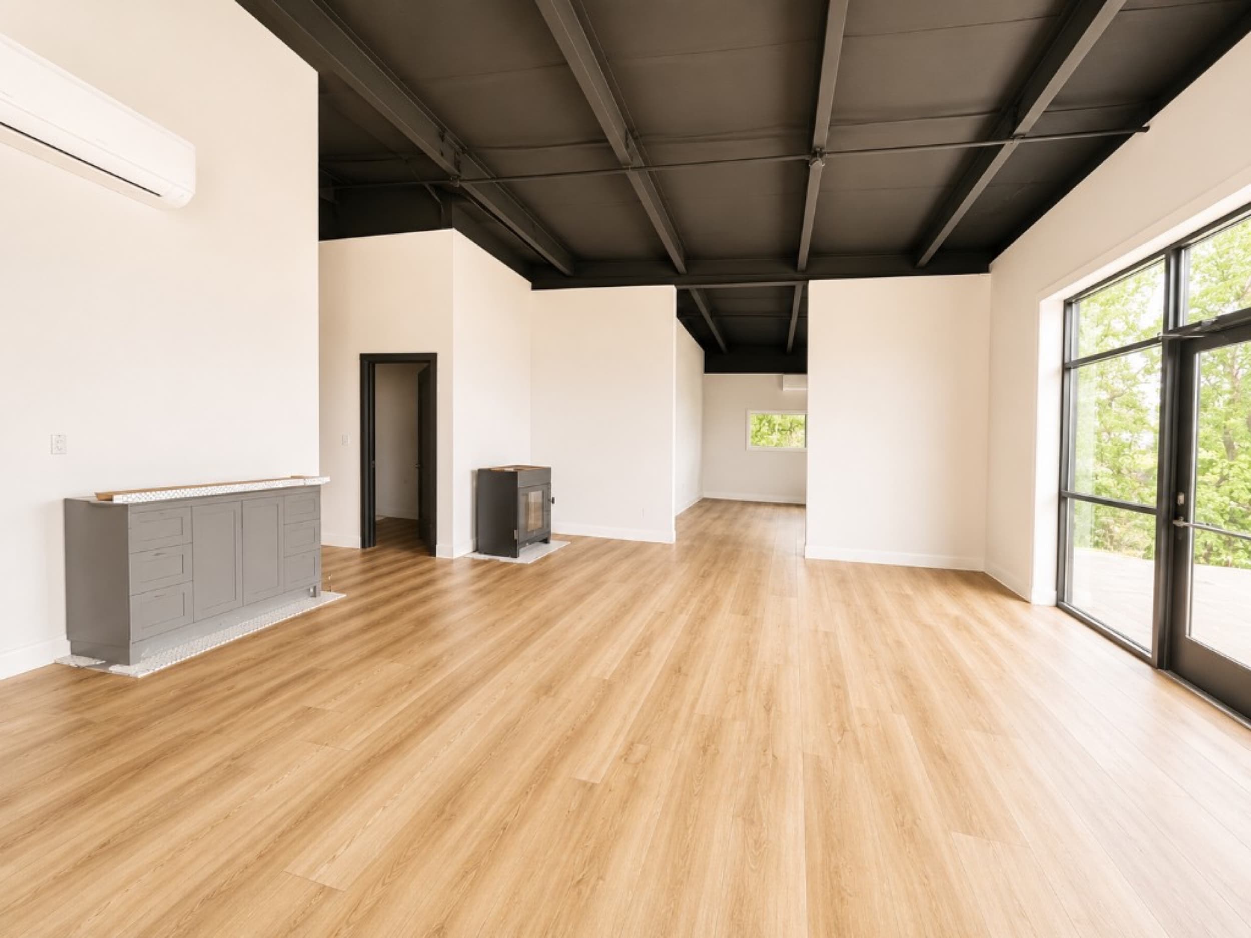 Kinsman Construction — wood-look LVP flooring with hex tile fireplace surround