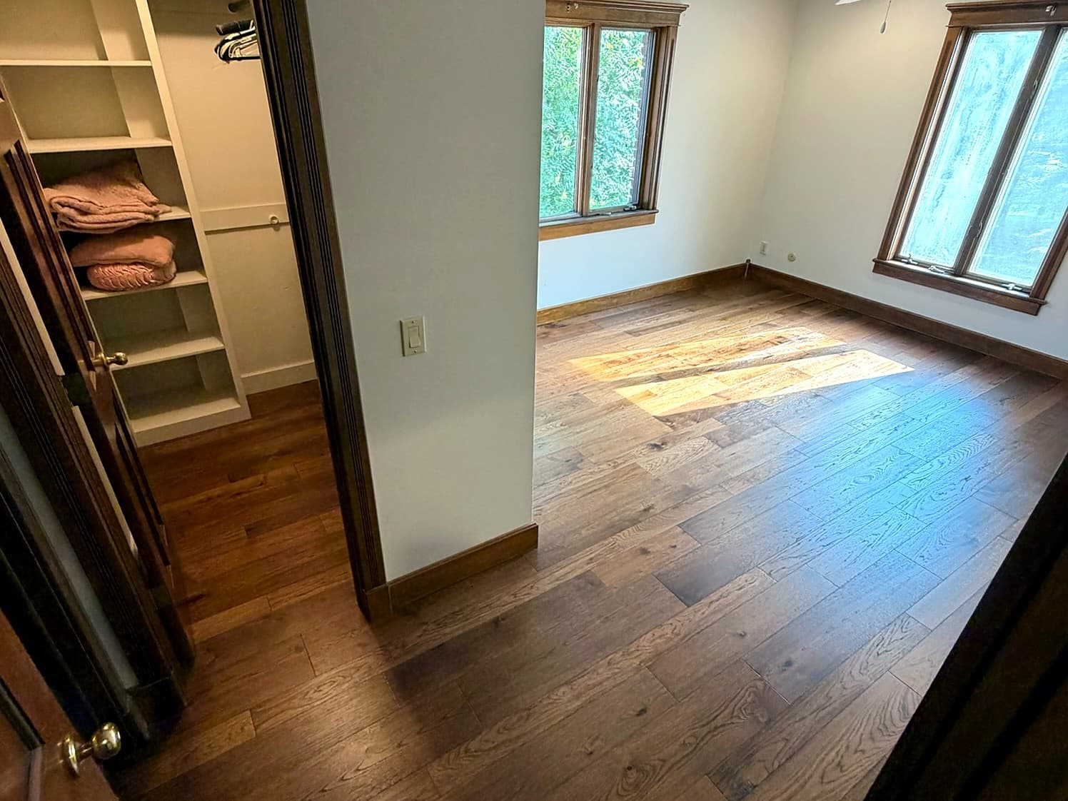Custom Springfield home — hardwood flooring continuing into a bedroom and closet