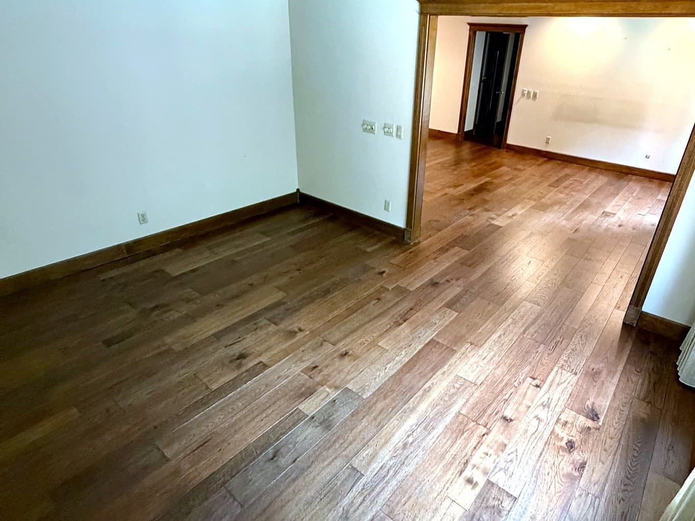 Custom Springfield home — hardwood flooring through a cased opening