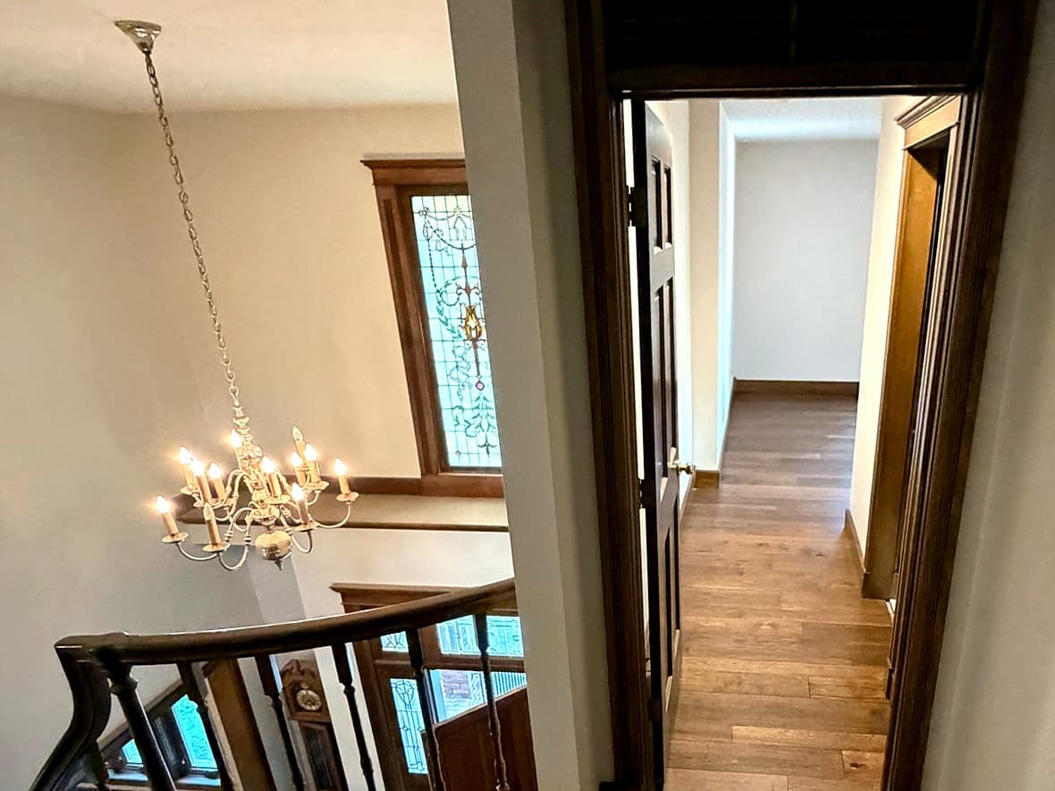 Custom Springfield home — hardwood landing, millwork, and stair hall
